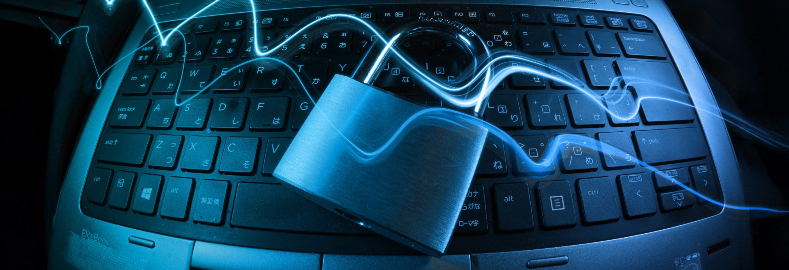 a closed padlock sat on top of a computer with a digital wave running over it
